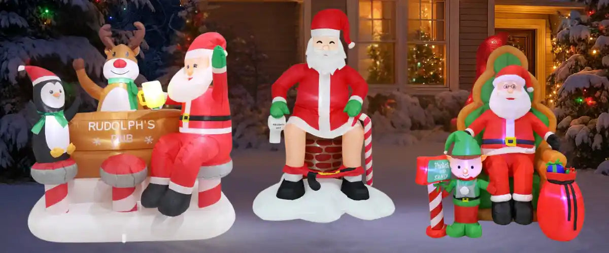 Christmas inflatable decorations featuring Santa, reindeer, penguin and elf characters displayed outdoors in a festive snowy setting.