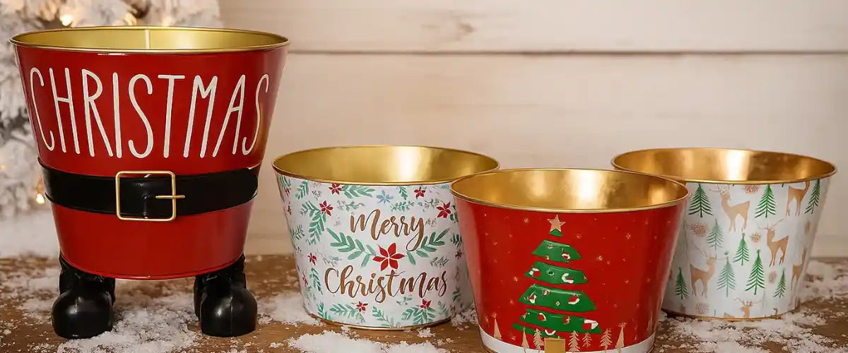 Christmas buckets featuring festive designs for gift giving, party treats, storage, table displays and seasonal Christmas décor.