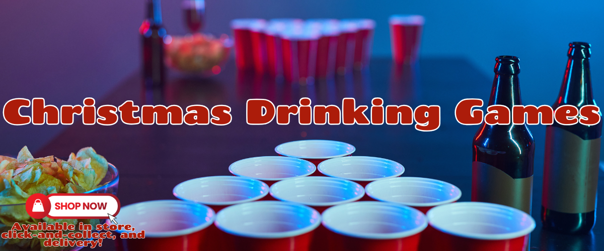 Festive Christmas drinking games set up on a cozy holiday table, with red and green cups, cards, and festive decorations like tinsel and snowflakes.