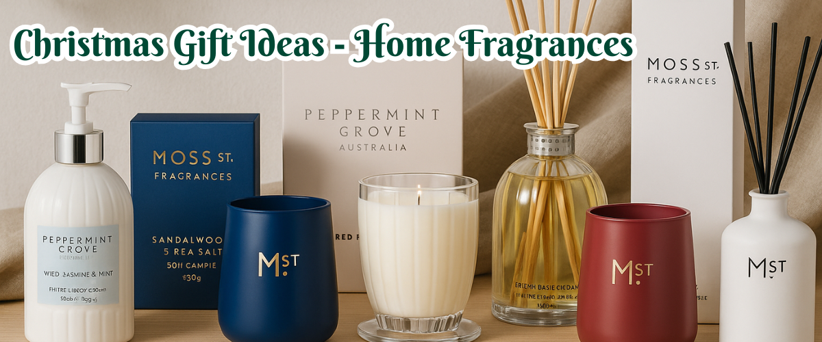 Christmas home fragrance gift set with festive diffusers, scented oils, and room sprays surrounded by pine and holiday decorations.