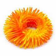 Orange and yellow stress ball on a white background.Squishy band bracelet – thumbnail