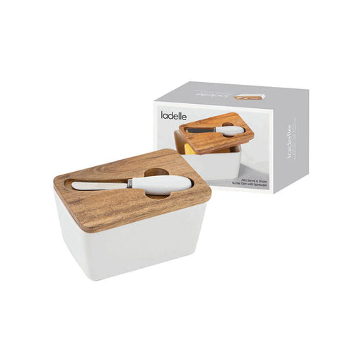 Lidded butter dish with matching spreader on table