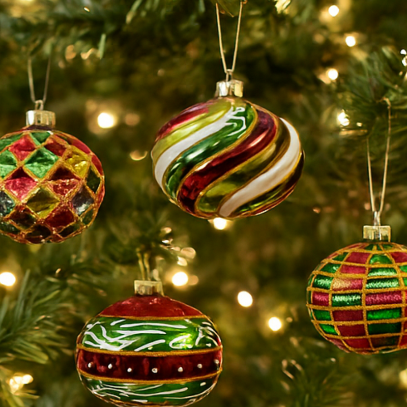 Colorful Christmas ornaments on a decorated tree with lights.