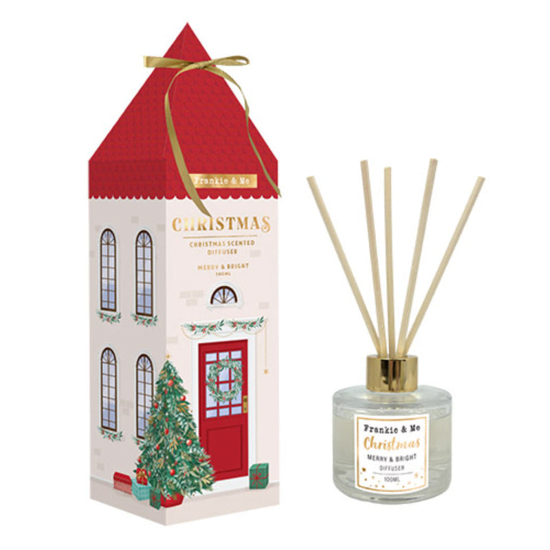Christmas reed diffuser in a house themed container on a console table.