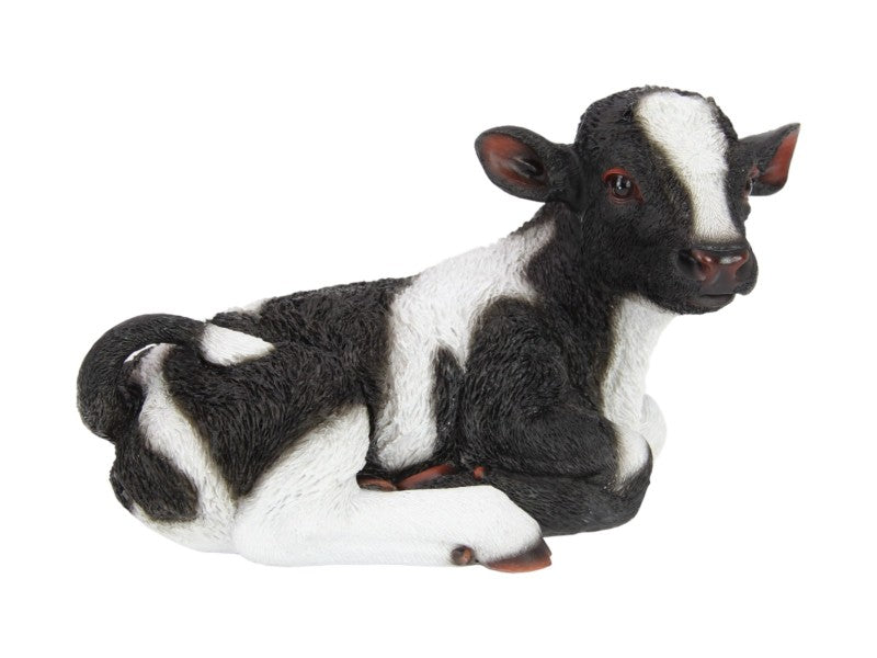 Realistic laying black and white cow figurine