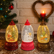 Assorted spinning Christmas globes with LED lights and festive scenes, 22.2cm tall