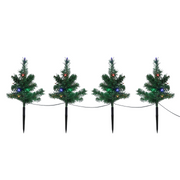Set of 4 Christmas tree-shaped LED path lights illuminating a garden walkway for the holidays