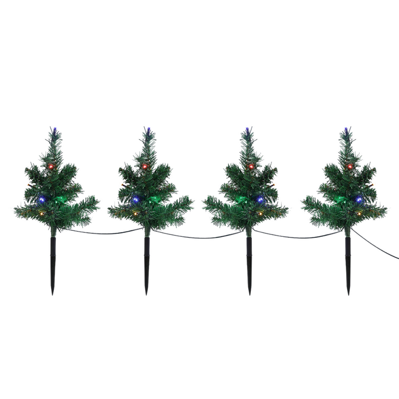 Set of 4 Christmas tree-shaped LED path lights illuminating a garden walkway for the holidays