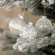 10cm clear shatterproof Christmas baubles with assorted white glitter snowflake and swirl designs