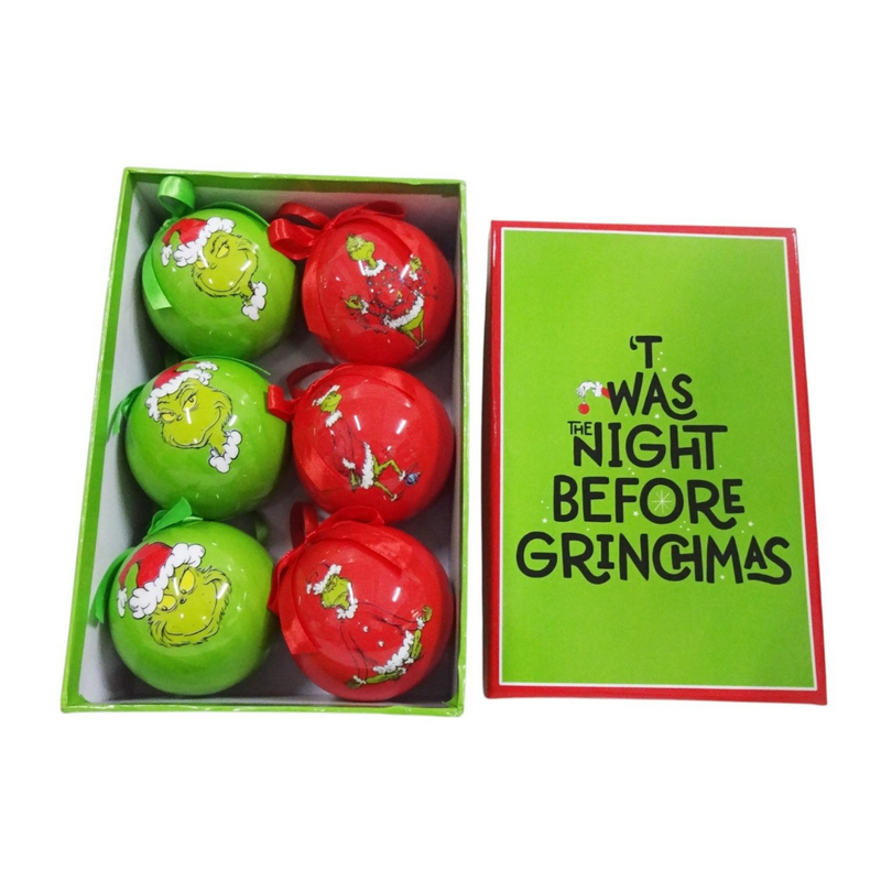 Set of 6 Grinch-themed Christmas baubles with festive designs, packaged in a Dr. Seuss holiday gift box.