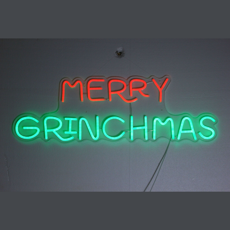 Dr. Seuss Neon Merry Grinchmas light sign featuring festive LED glow and whimsical Grinch-themed holiday lettering.