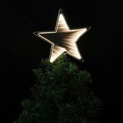 Infinity LED tree topper with glowing mirror light effect on a decorated Christmas tree