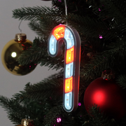 Infinity mirror candy cane with glowing LED lights hanging in a Christmas-themed room