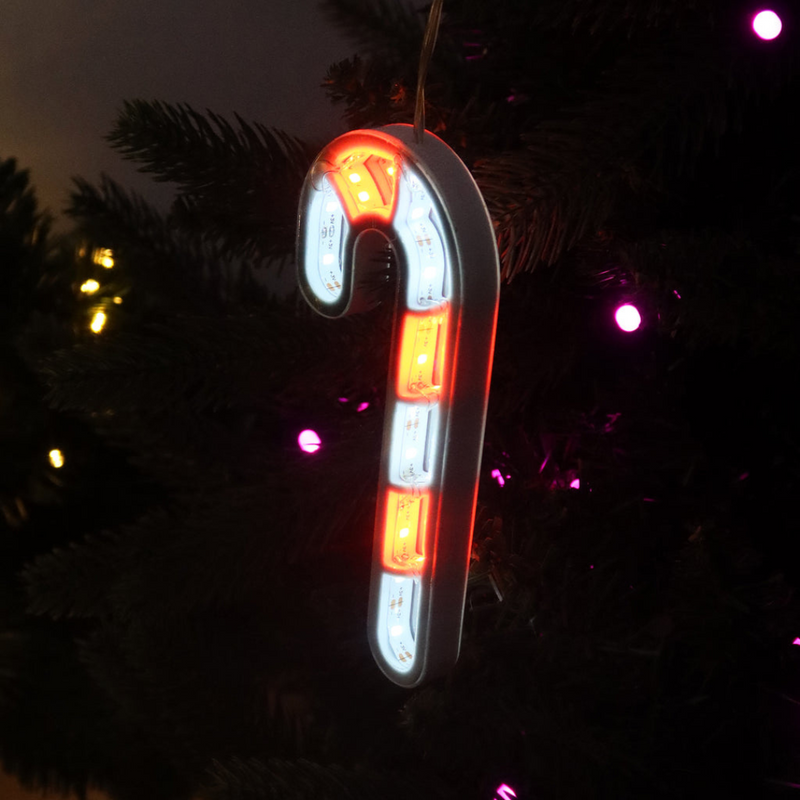 Infinity mirror candy cane with glowing LED lights hanging in a Christmas-themed room