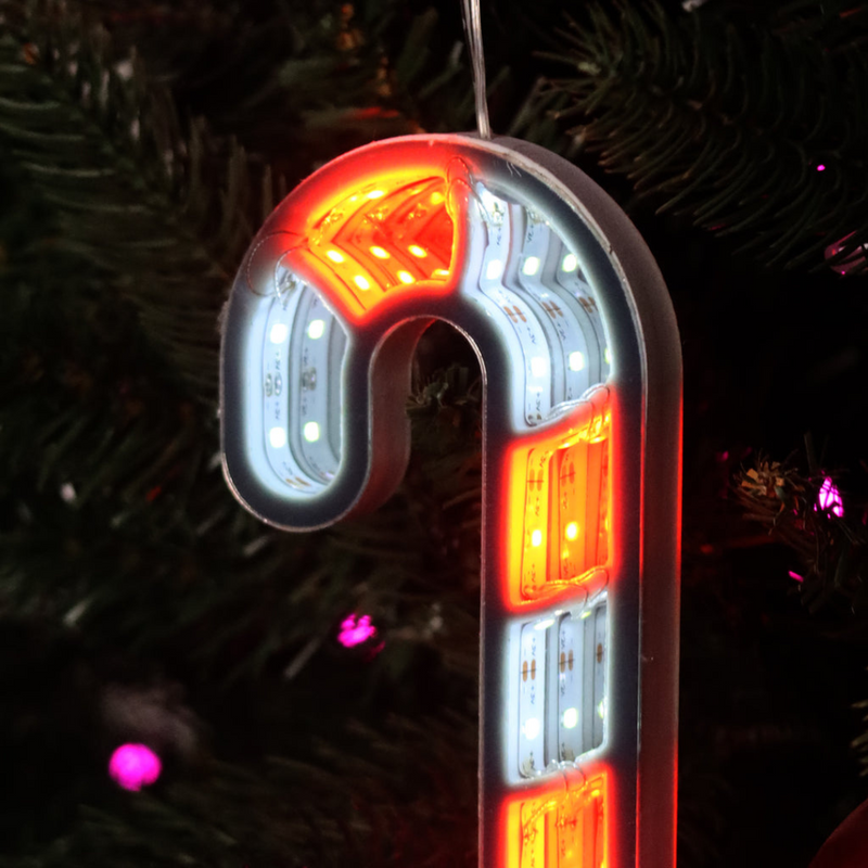 Infinity mirror candy cane with glowing LED lights hanging in a Christmas-themed room