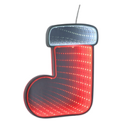 Infinity mirror Christmas boot with glowing LED lights hanging on a holiday-themed wall