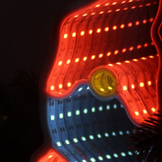 Infinity mirror Christmas gonk decoration glowing with LED lights hanging on a festive wall