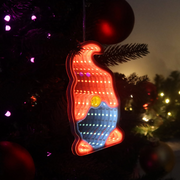Infinity mirror Christmas gonk decoration glowing with LED lights hanging on a festive wall