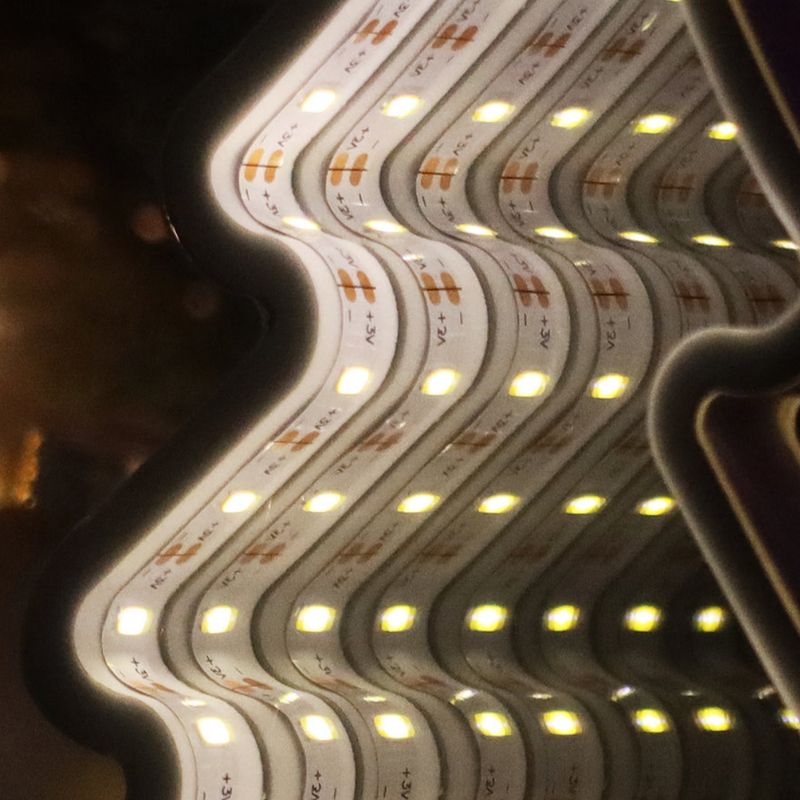 Infinity mirror LED hanging Christmas tree glowing in warm white light with 3D tunnel effect