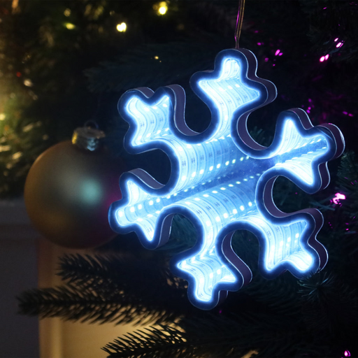 Infinity mirror snowflake decoration with glowing LED lights hanging in a festive indoor setting