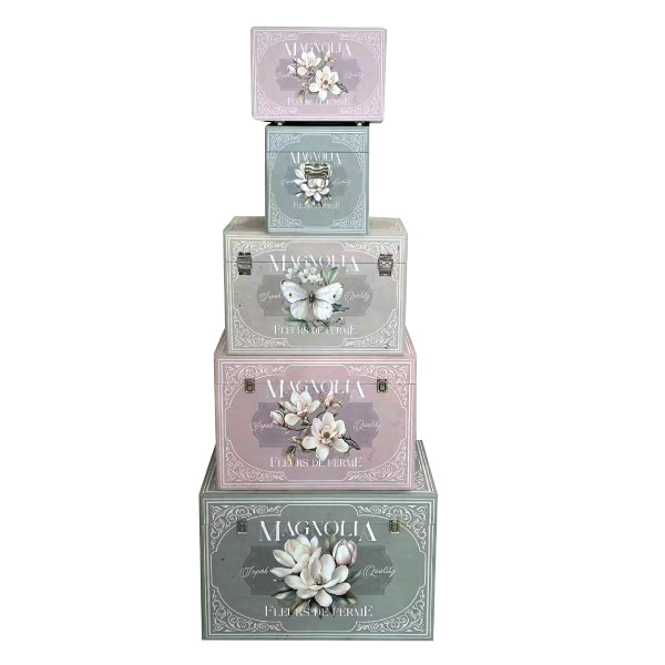A nesting set of five decorative storage trunks featuring a vintage Magnolia floral design.