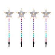 LED shooting star garden light glowing brightly in an outdoor lawn at night