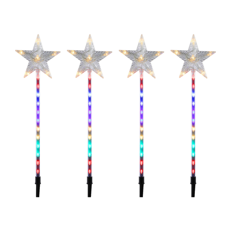 LED shooting star garden light glowing brightly in an outdoor lawn at night