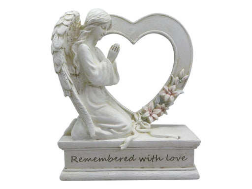 Small memorial angel holding heart statue