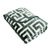 Folded blanket with geometric pattern on a white background
