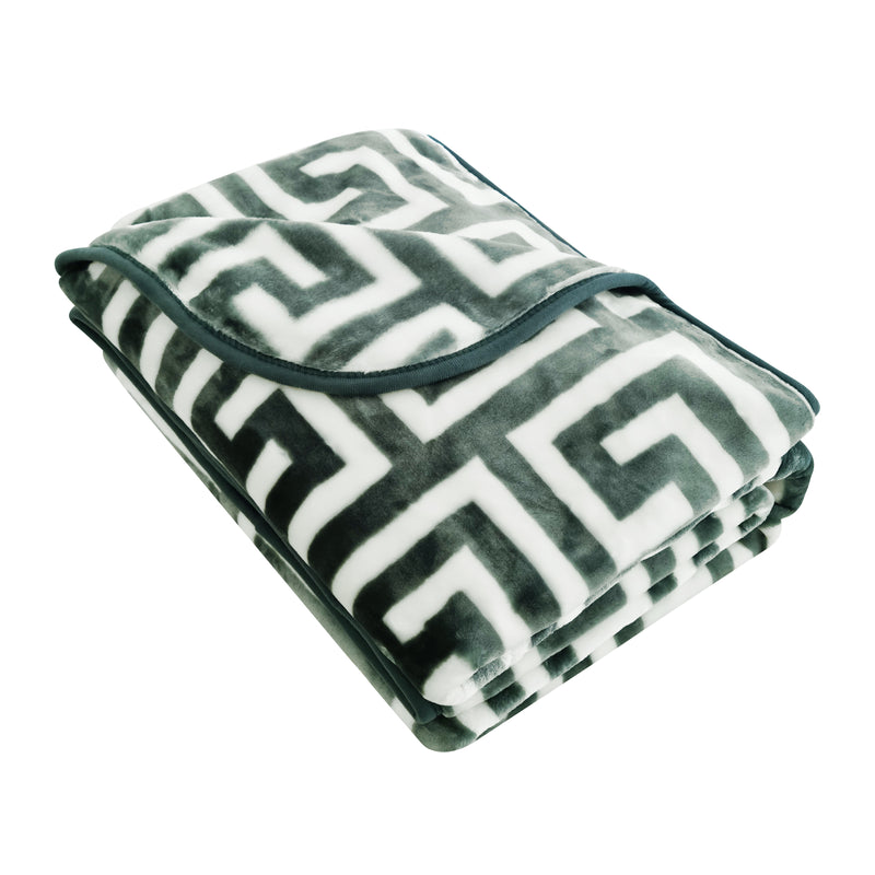 Folded blanket with geometric pattern on a white background