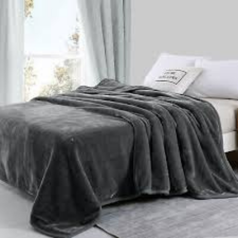 Gray blanket draped over a bed in a bedroom setting