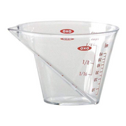 OXO Good Grips Mini Angled Measuring Cup with top-down measurement markings and soft non-slip handle.