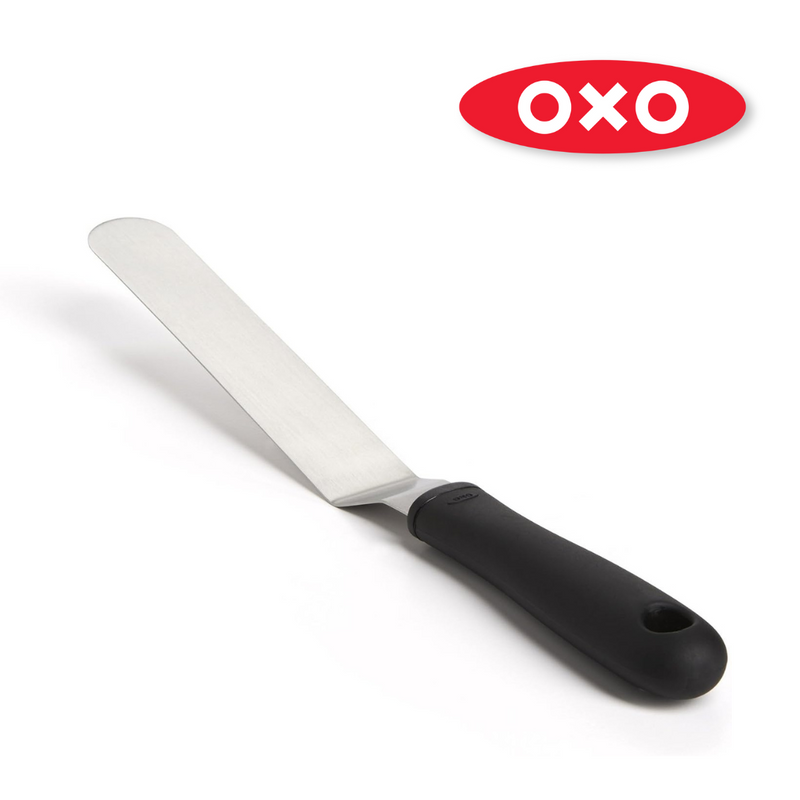OXO Good Grips Bent Icing Knife with angled stainless steel blade and soft non-slip handle for smooth cake decorating.