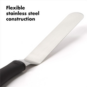OXO Good Grips Bent Icing Knife with angled stainless steel blade and soft non-slip handle for smooth cake decorating.
