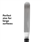 OXO Good Grips Bent Icing Knife with angled stainless steel blade and soft non-slip handle for smooth cake decorating.