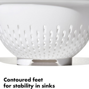 OXO Good Grips Colander with perforated holes, elevated base, and soft non-slip handles.