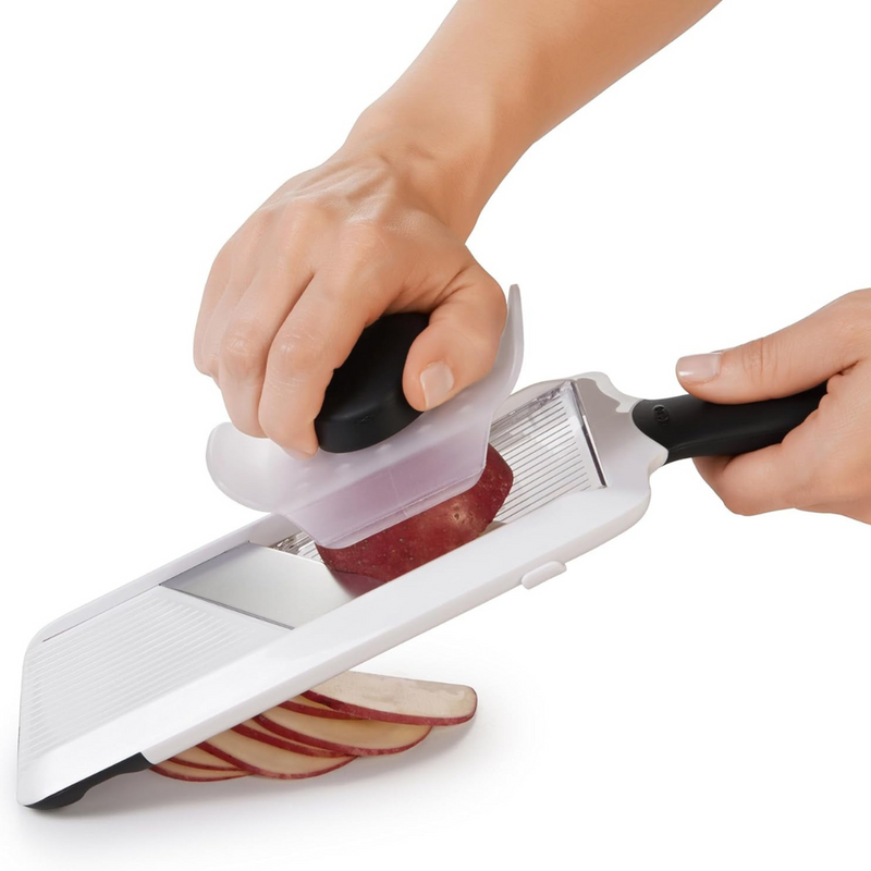 OXO Good Grips Hand-Held Mandoline Slicer with adjustable stainless steel blade and non-slip handle for precise fruit and vegetable slicing.
