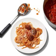 OXO Good Grips Polished Stainless Steel Slotted Spoon with deep slotted bowl and soft non-slip handle.