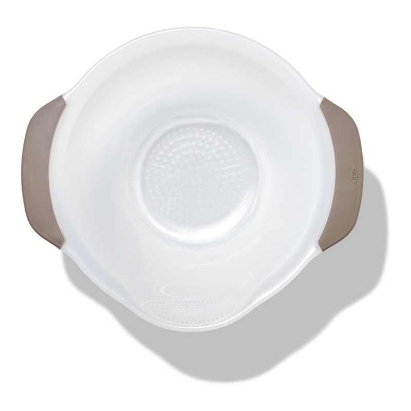 OXO Good Grips Rice and Grain Washing Colander with fine drainage holes and soft non-slip handles.