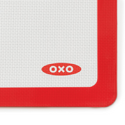 OXO Good Grips Silicone Baking Mat with measurement markings, non-stick surface, and half-sheet pan fit.