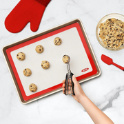 OXO Good Grips Silicone Baking Mat with measurement markings, non-stick surface, and half-sheet pan fit.