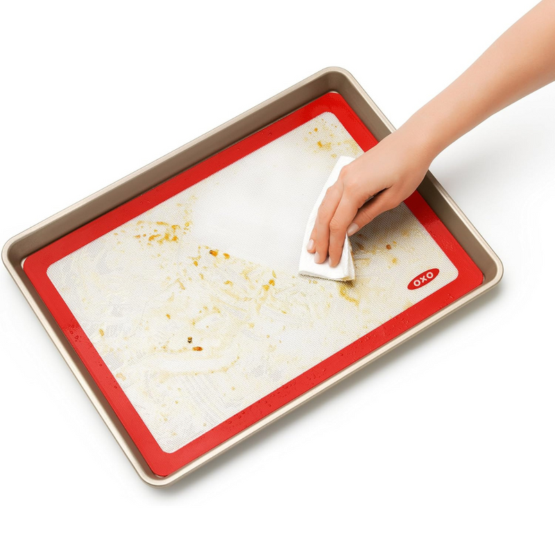 OXO Good Grips Silicone Baking Mat with measurement markings, non-stick surface, and half-sheet pan fit.