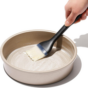 OXO Good Grips Silicone Basting Brush with heat-resistant bristles and non-slip handle for even sauce coating.