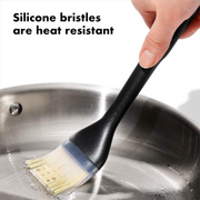 OXO Good Grips Silicone Basting Brush with heat-resistant bristles and non-slip handle for even sauce coating.