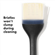 OXO Good Grips Silicone Basting Brush with heat-resistant bristles and non-slip handle for even sauce coating.