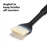 OXO Good Grips Silicone Basting Brush with heat-resistant bristles and non-slip handle for even sauce coating.