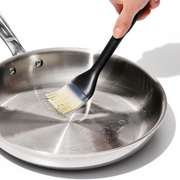 OXO Good Grips Silicone Basting Brush with heat-resistant bristles and non-slip handle for even sauce coating.