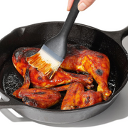 OXO Good Grips Silicone Basting Brush with heat-resistant bristles and non-slip handle for even sauce coating.