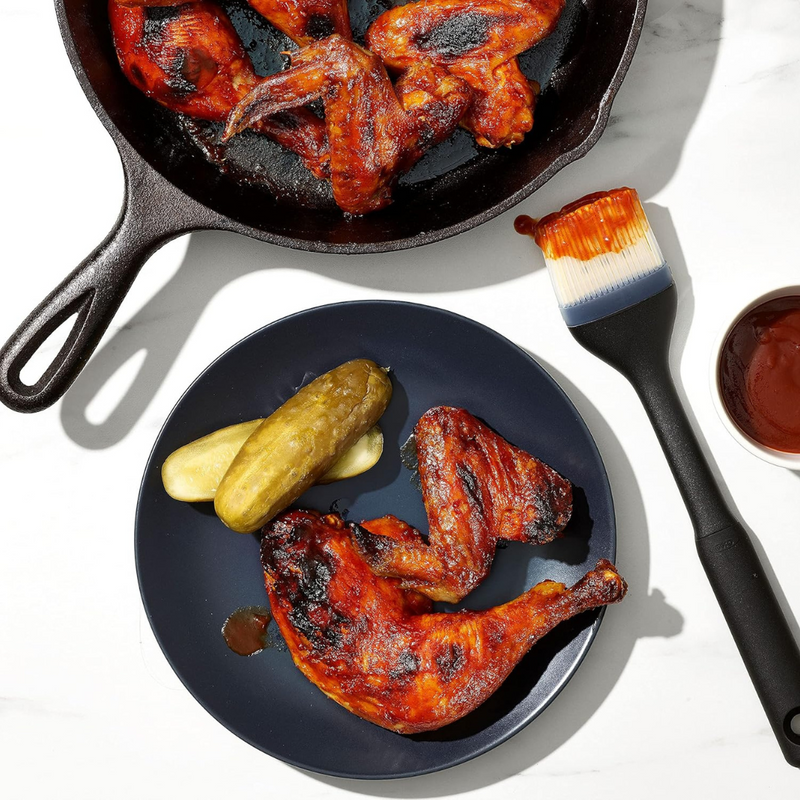 OXO Good Grips Silicone Basting Brush with heat-resistant bristles and non-slip handle for even sauce coating.