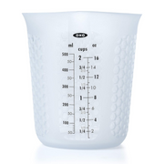 OXO Good Grips 2-Cup / 500ml Squeeze & Pour Measuring Cup with flexible silicone body and clear measurement markings.